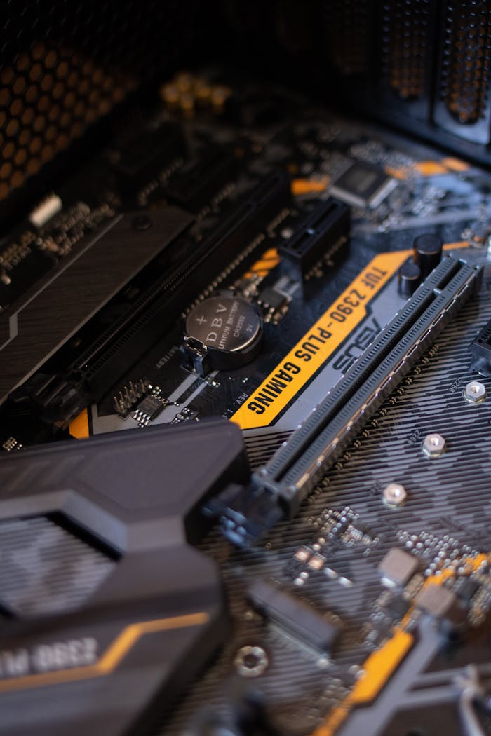 who-we-are Detailed view of a gaming motherboard with capacitors and microchips.